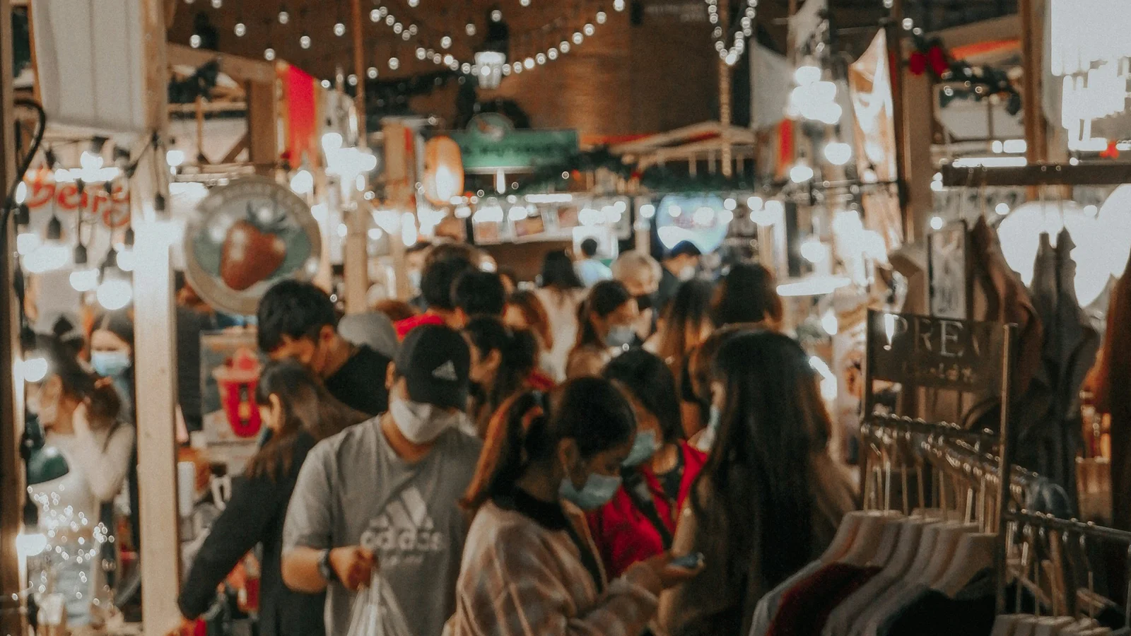People gathering beneath lights at a Chiang Mai night market